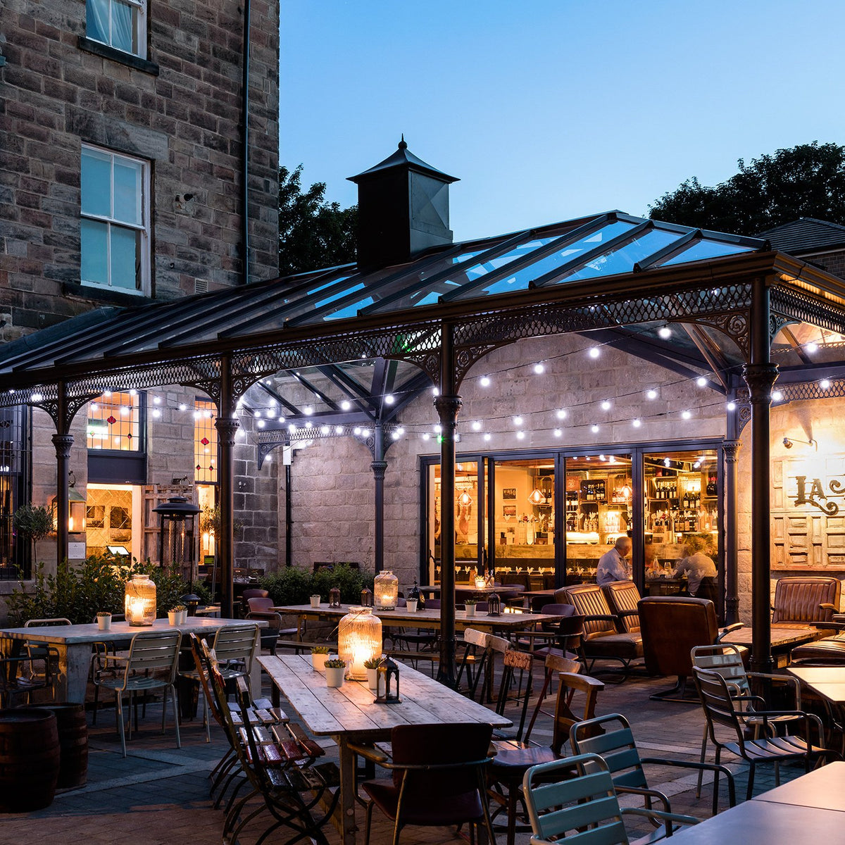 Beleuchtete Pro Connect Lichterketten in Glasüberdachtem Außenbereich eines Restaurants bei Nacht