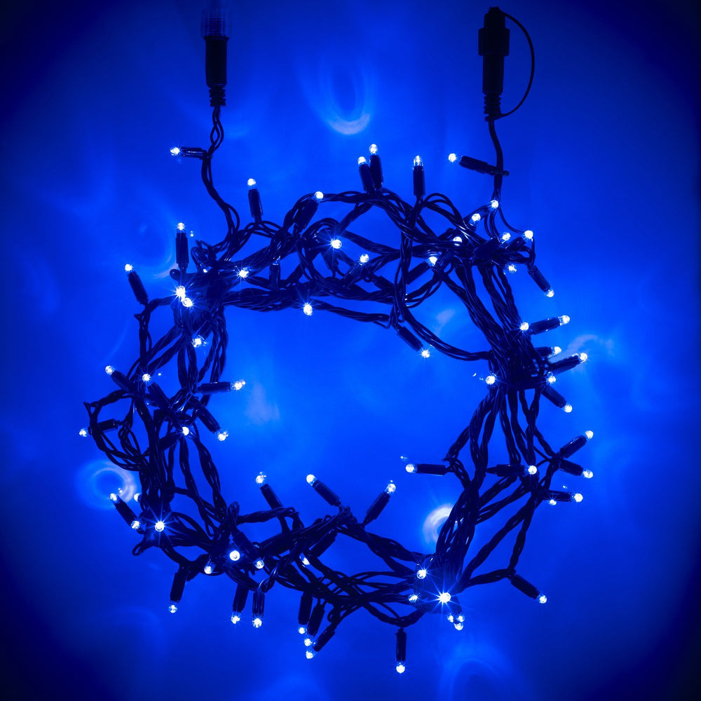 Blaue LED Lichterkette mit grünem Kabel in Kreisform auf blauem Hintergrund